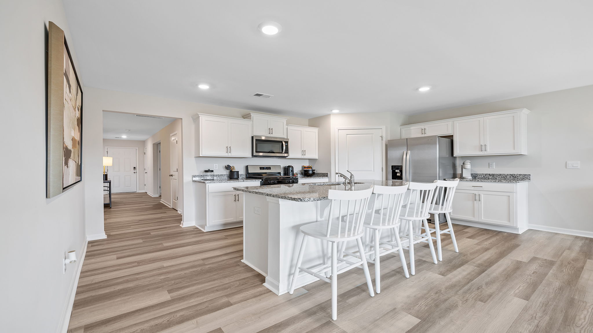 Kitchen and island with granite counter tops.