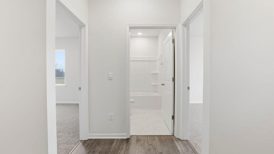 View of entrances to the bedrooms and hall bathroom.