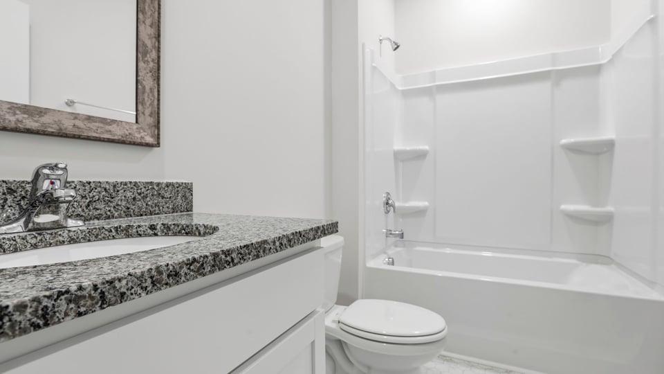 Hall bathroom with vanity and combination shower / tub.