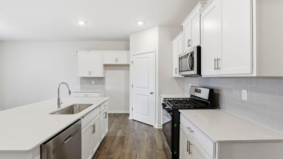 Large kitchen with lots of cabinets.