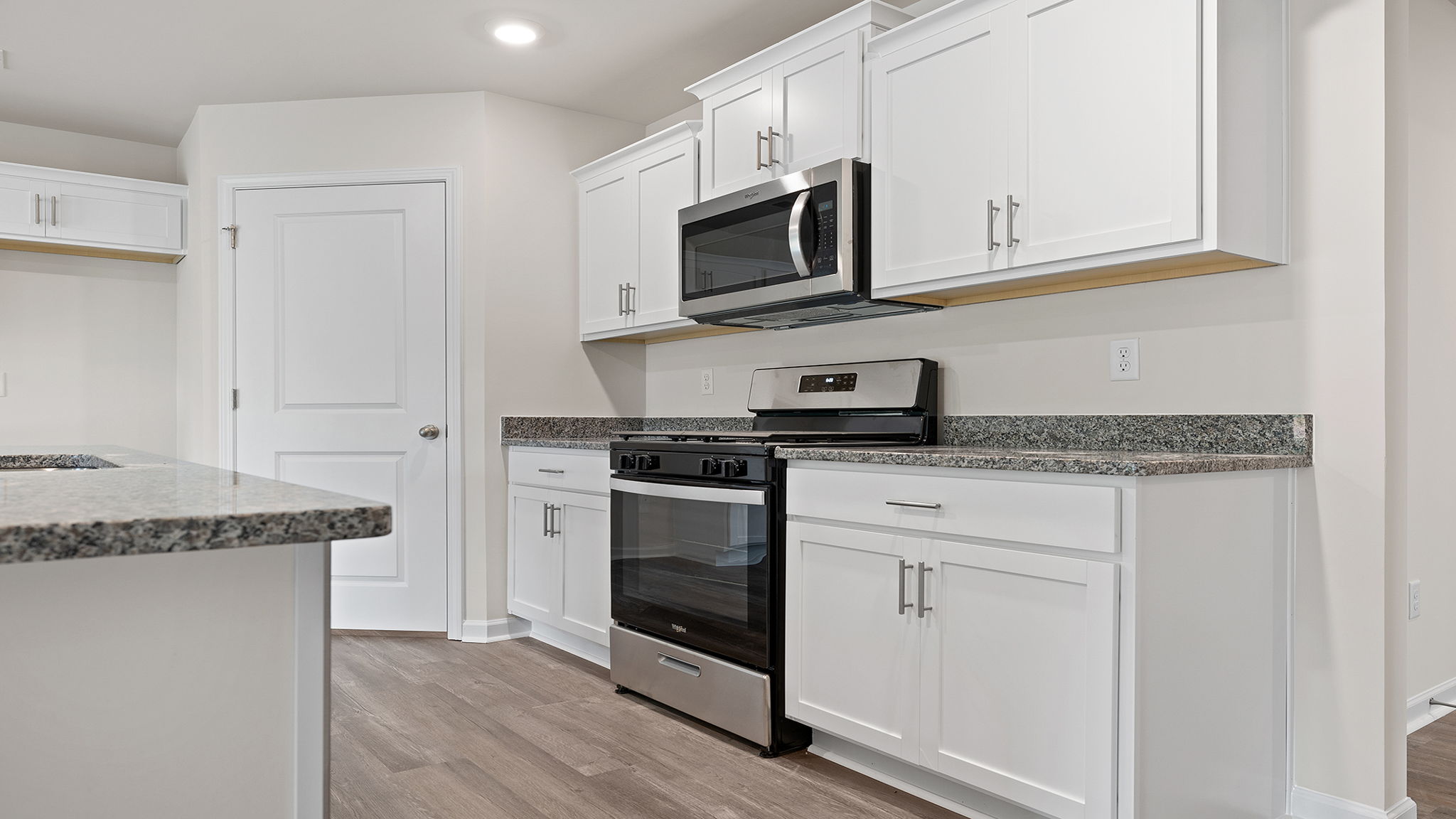 Kitchen with island and granite countertops.