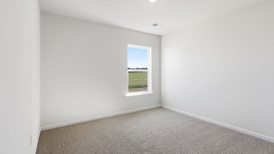 Bedroom with carpet and windows.
