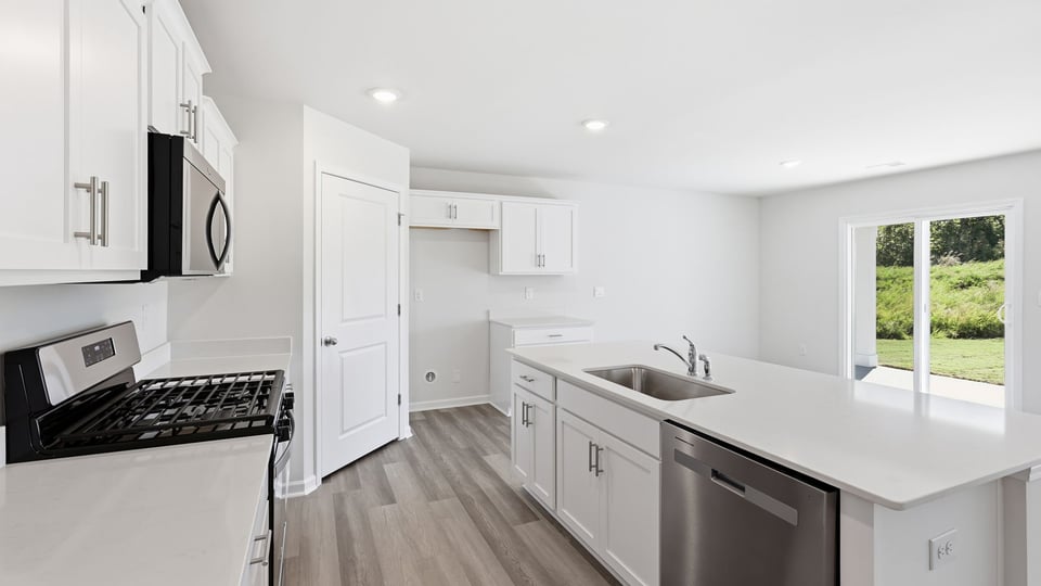 Kitchen with island and cabinets.