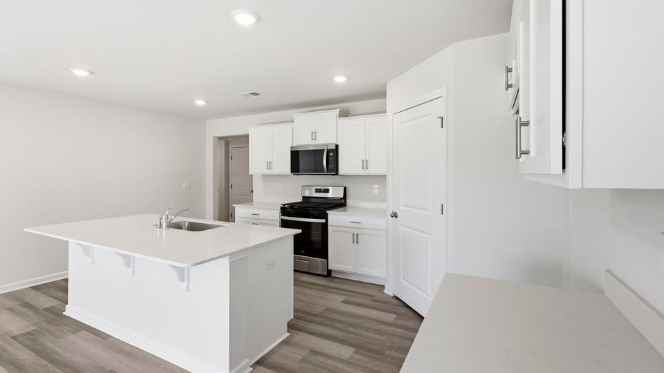Kitchen with island and cabinets.