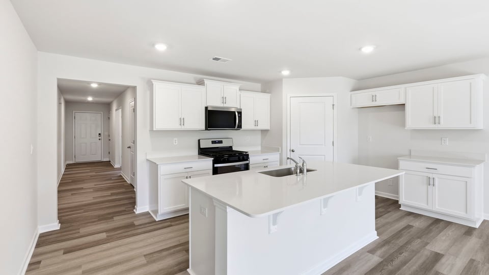 Kitchen with island and cabinets.