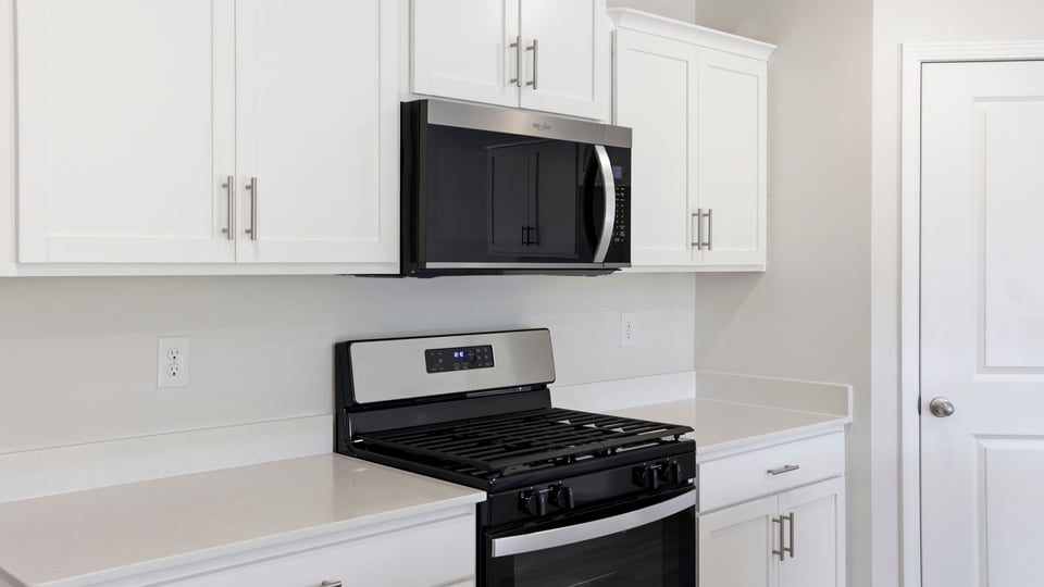 Kitchen with island and cabinets.