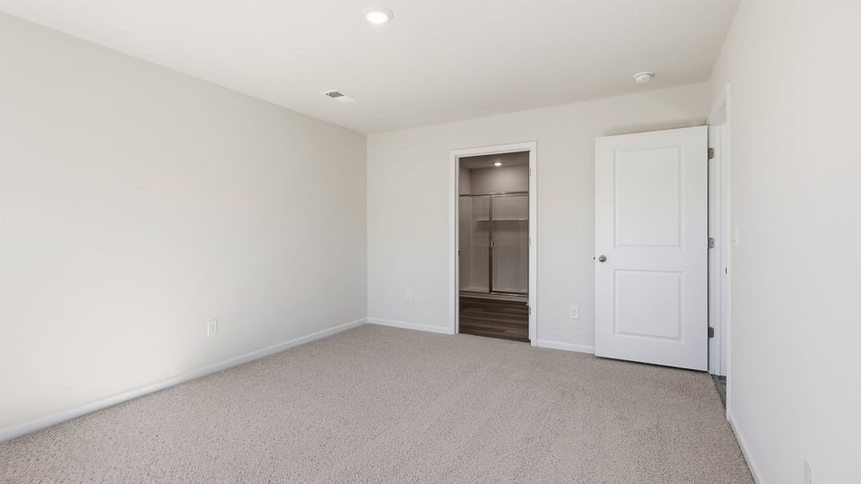 Bedroom with carpet and windows.