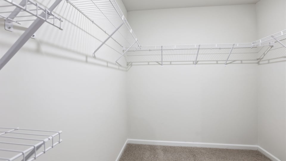 Primary closet with shelf.
