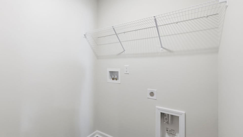 Laundry room with shelf.