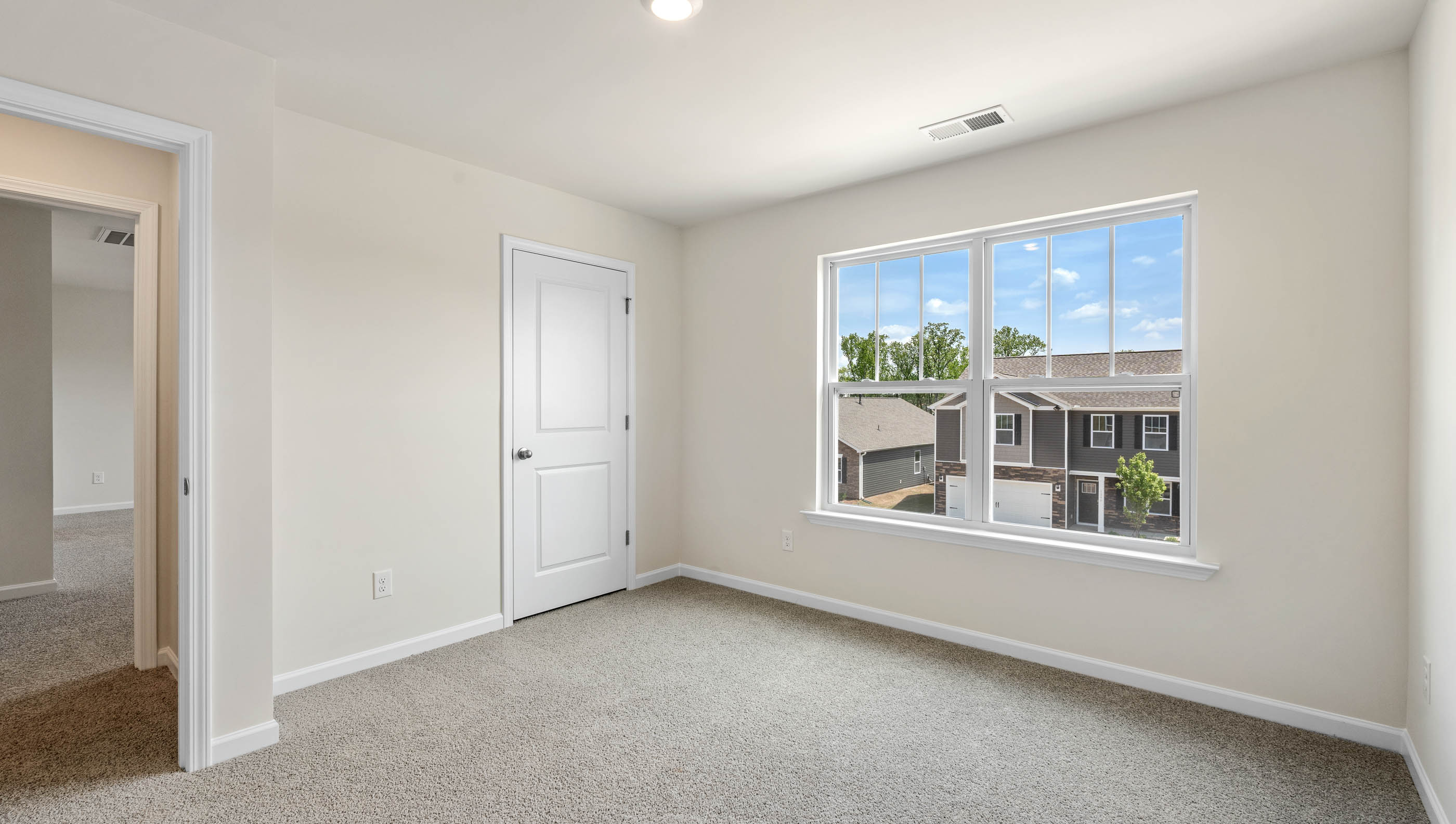 Bedroom with double window and carpet.