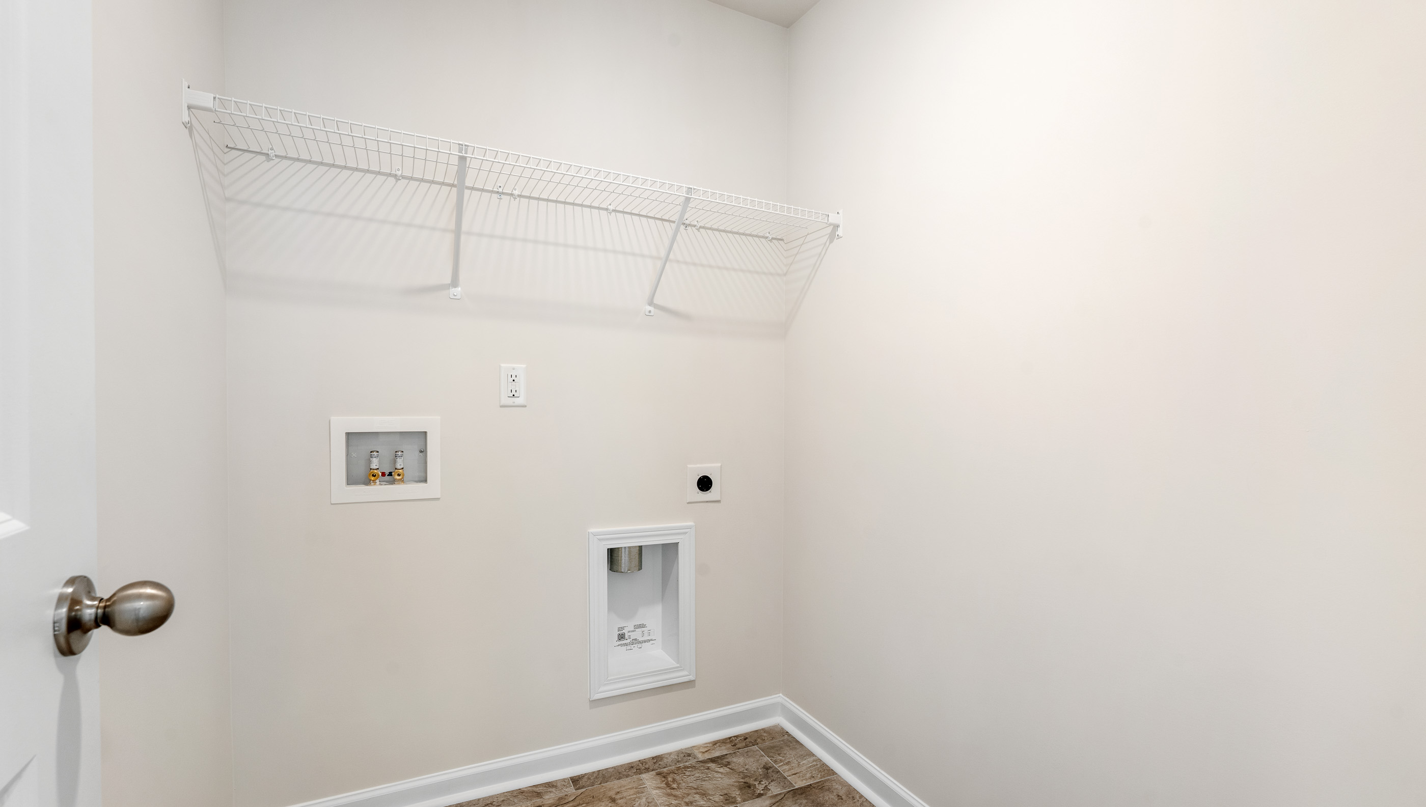 Walk in laundry room with shelving.