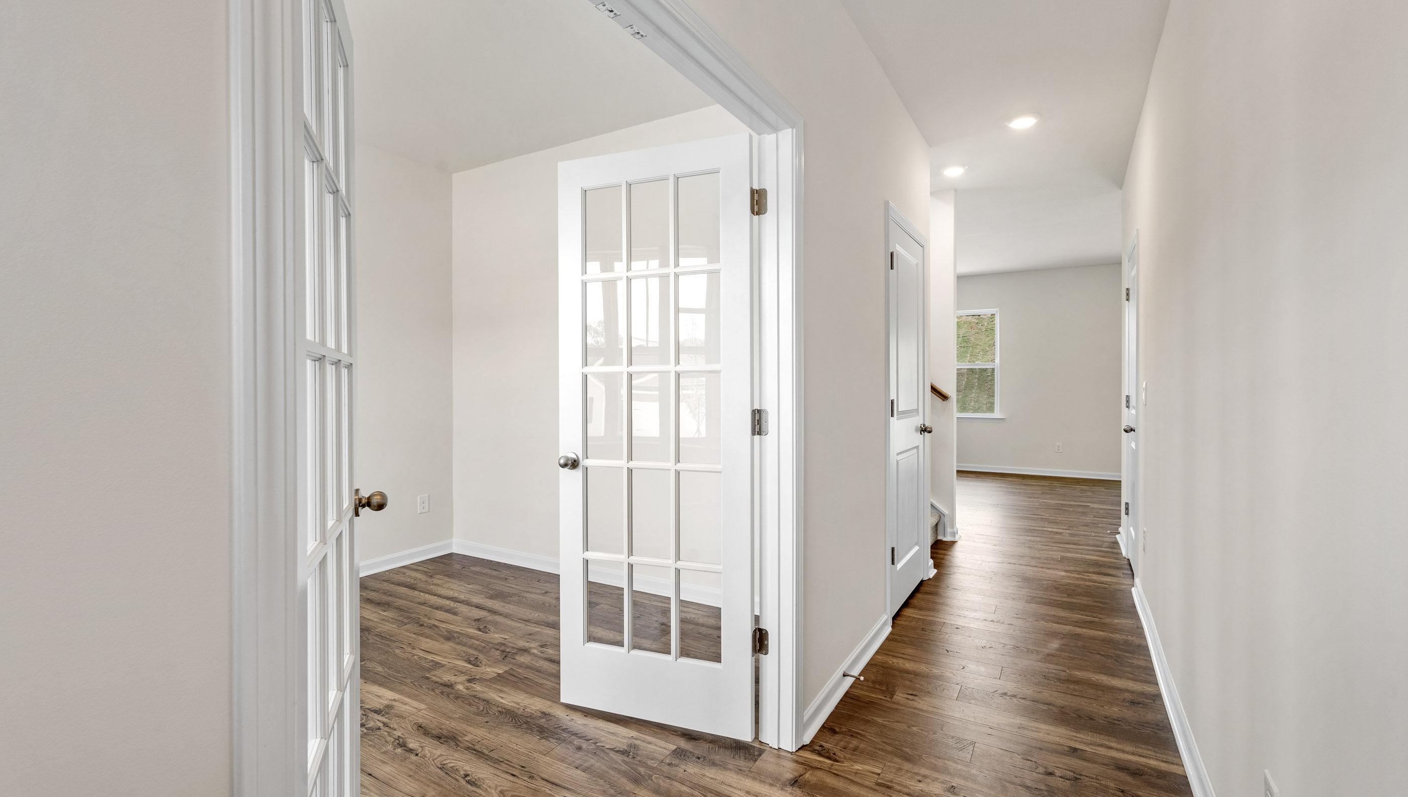 View of hallway to the living area and French doors to the study.