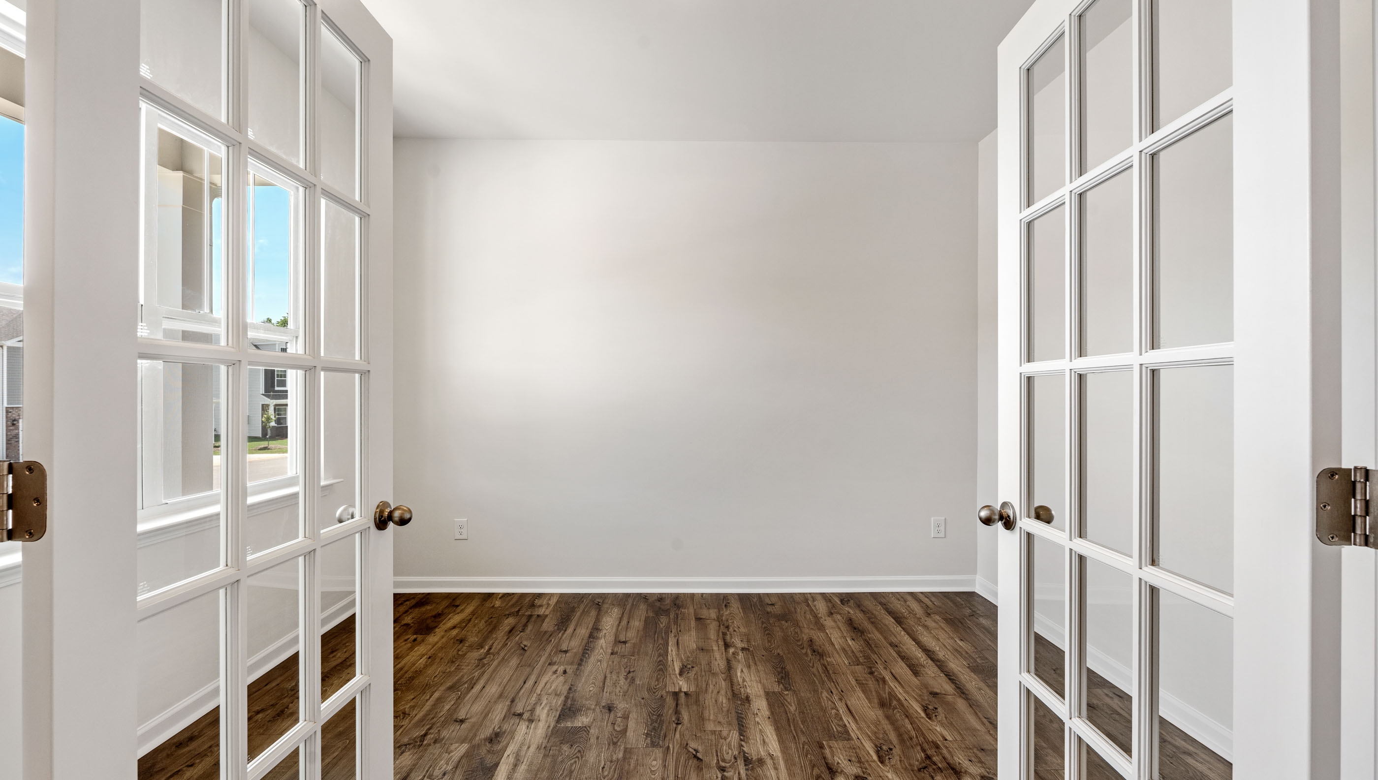View of study with accenting French doors.
