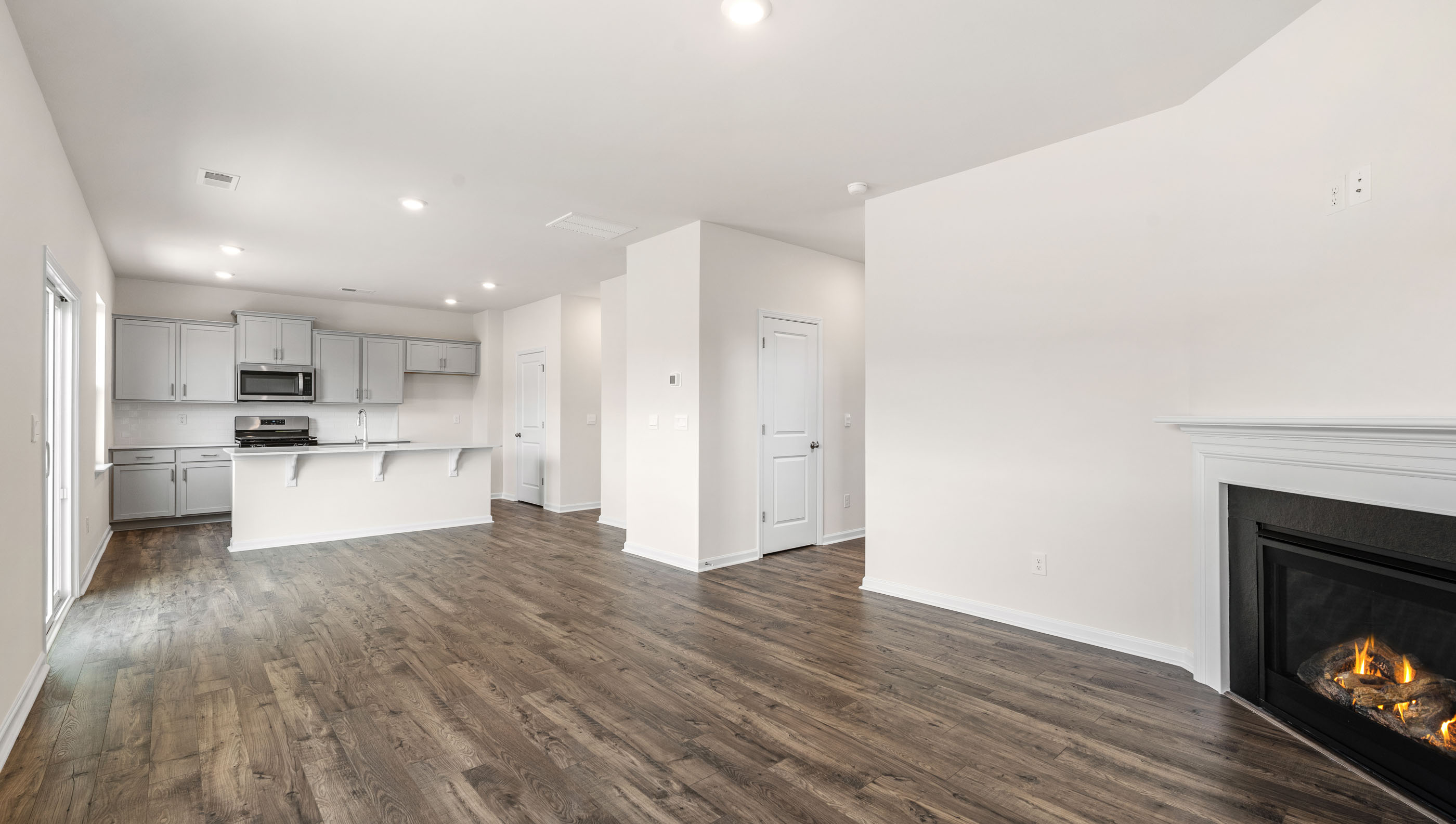 View from family room of combination living and dining areas open to the kitchen.