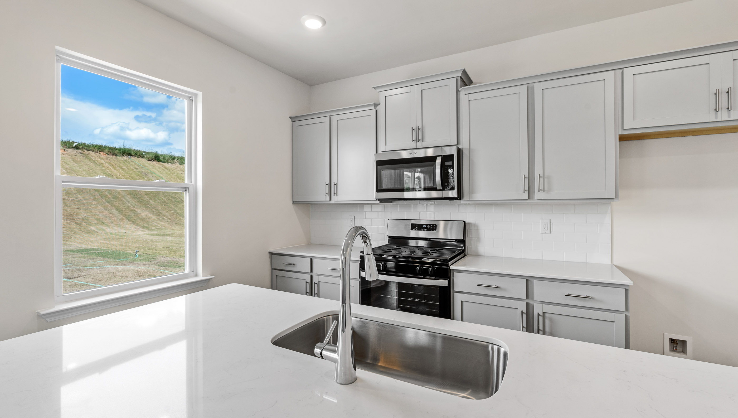 Kitchen has large window to brighten it up.