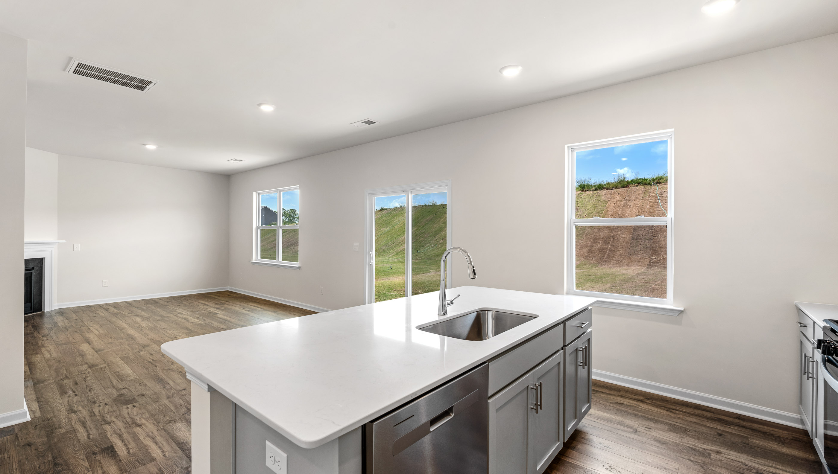 View of large windows and patio door to the backyard, providing lots of natural light.