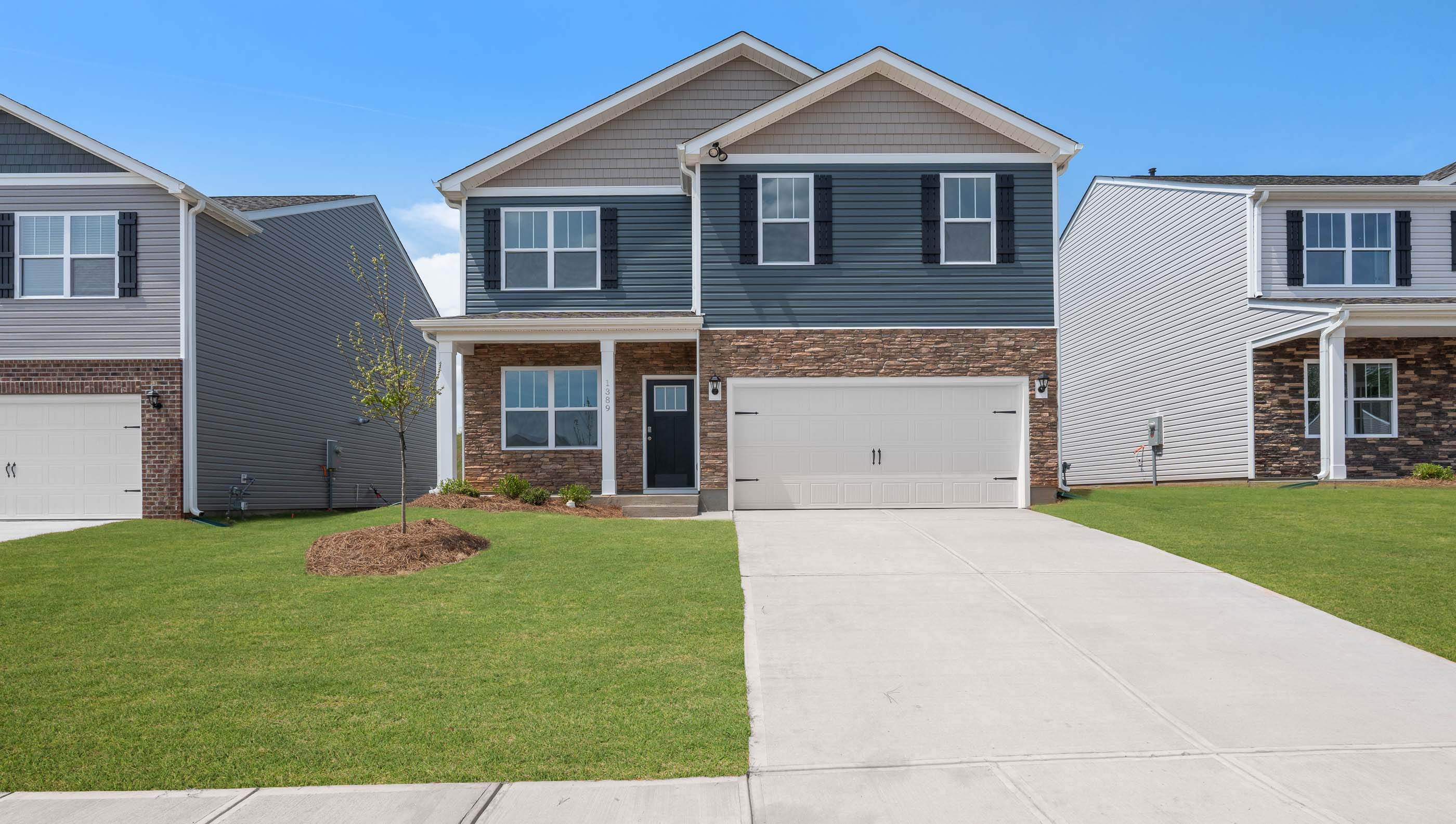 View of the front of Belhaven home with driveway and covered front porch entry.