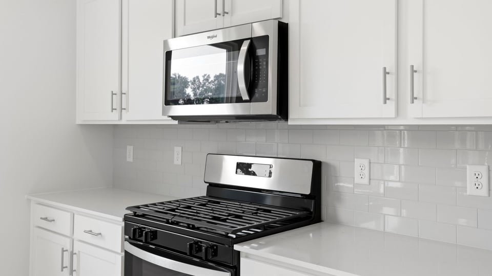 Kitchen and island with quartz countertops.