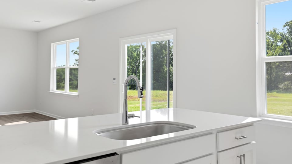 Kitchen and island with quartz countertops.