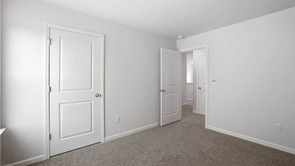 Bedroom with carpet and window.