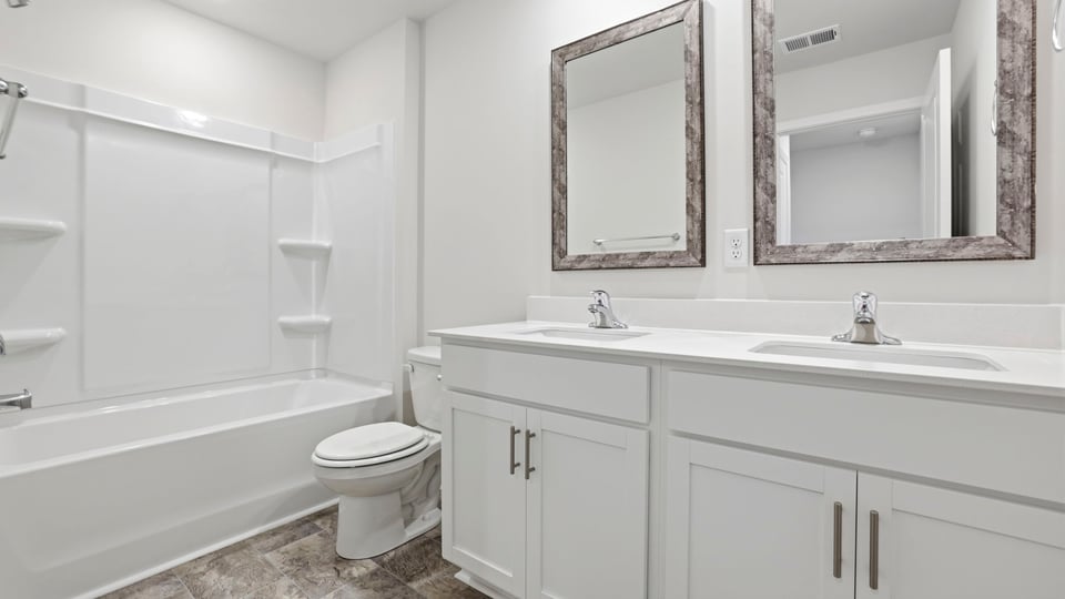 Bathroom with double vanity sink and bathtub.