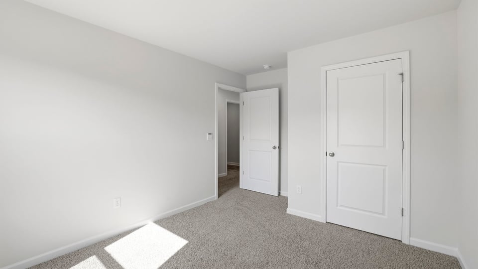 Bedroom with carpet and window.