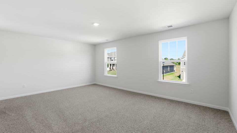 Bedroom with carpet and window.