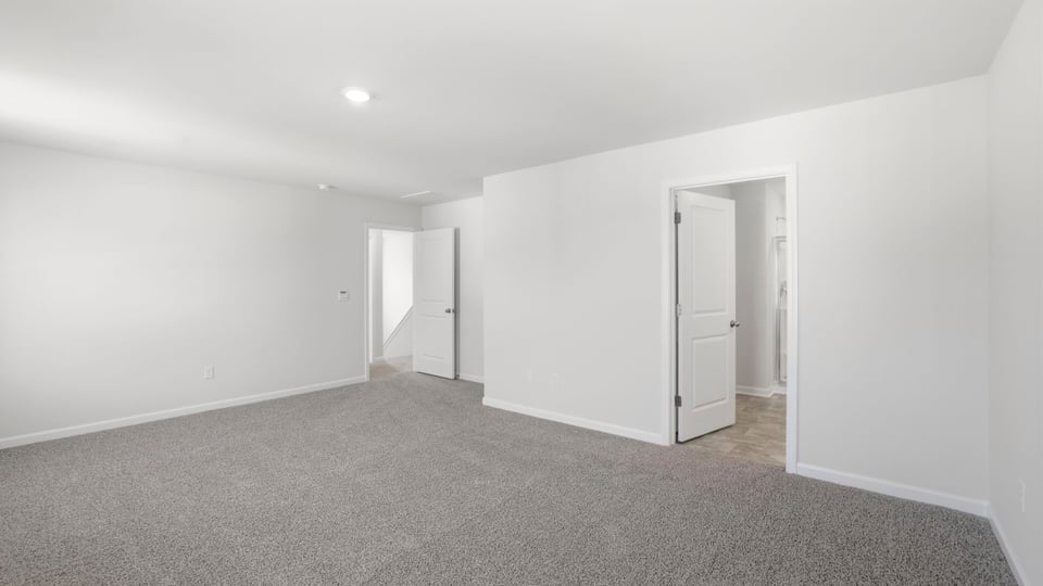 Bedroom with carpet and window.