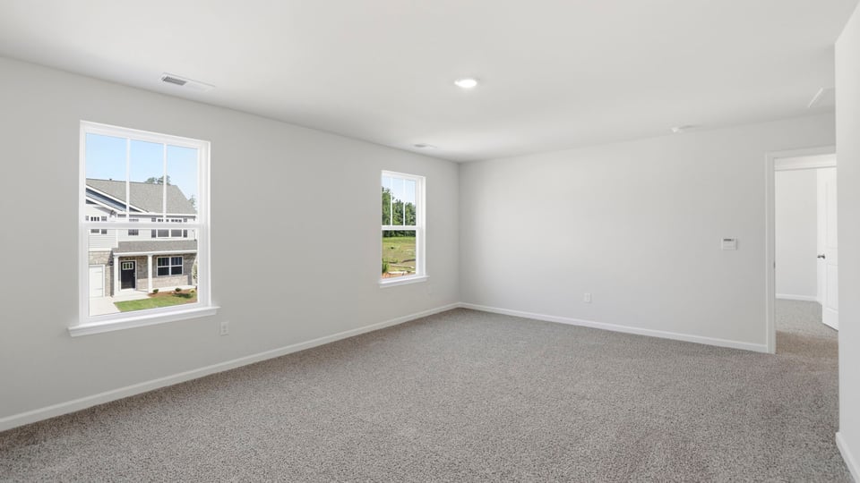 Bedroom with carpet and window.