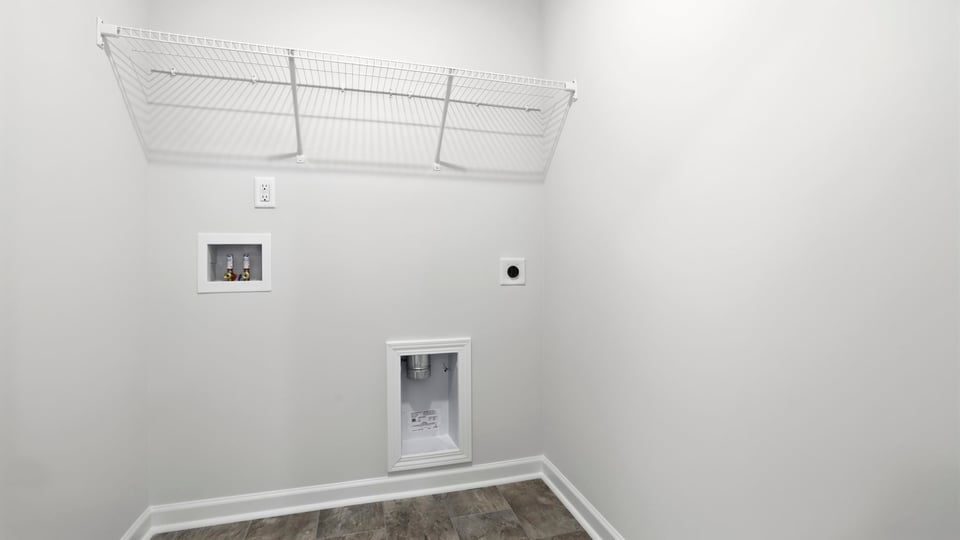 Laundry room with hanging storage racks.