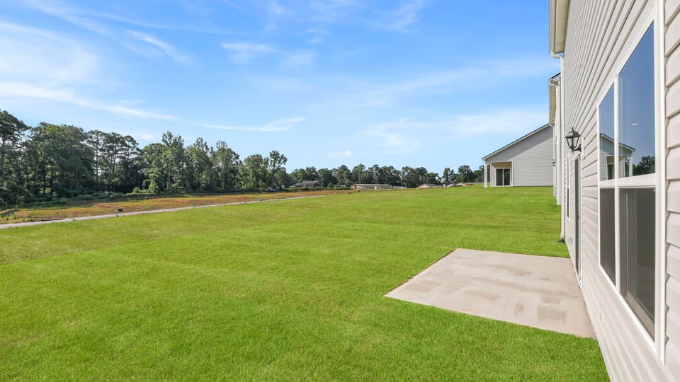 Back exterior of home with patio.