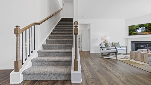 Stairs with view of living area.