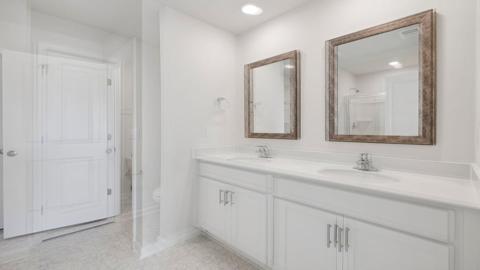 Primary bathroom with dual sink vanity.