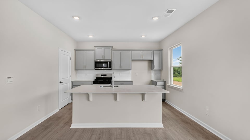 Kitchen and island with quarz countertops.