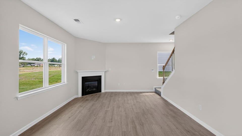 Family room with fireplace and windows.