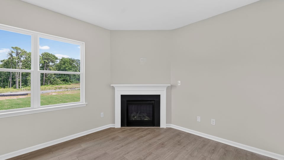 Family room with fireplace and windows.