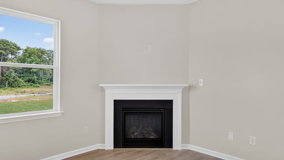 Family room with fireplace and windows.