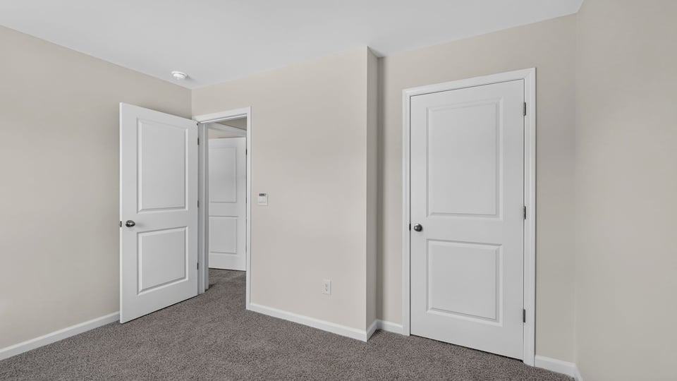 Bedroom with carpet and window.