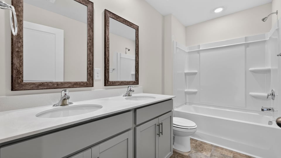 Bathroom with double vanity sink and bathtub