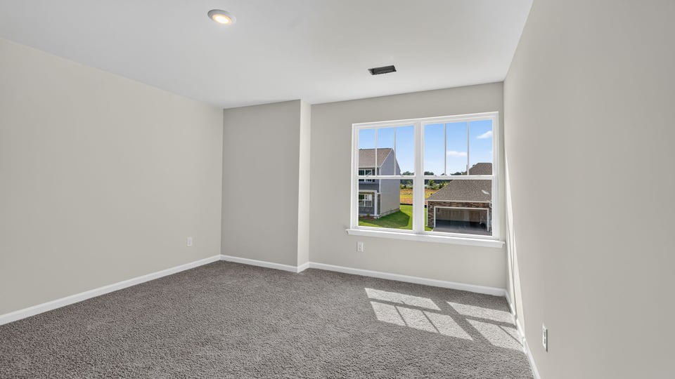 Bedroom with carpet and window.