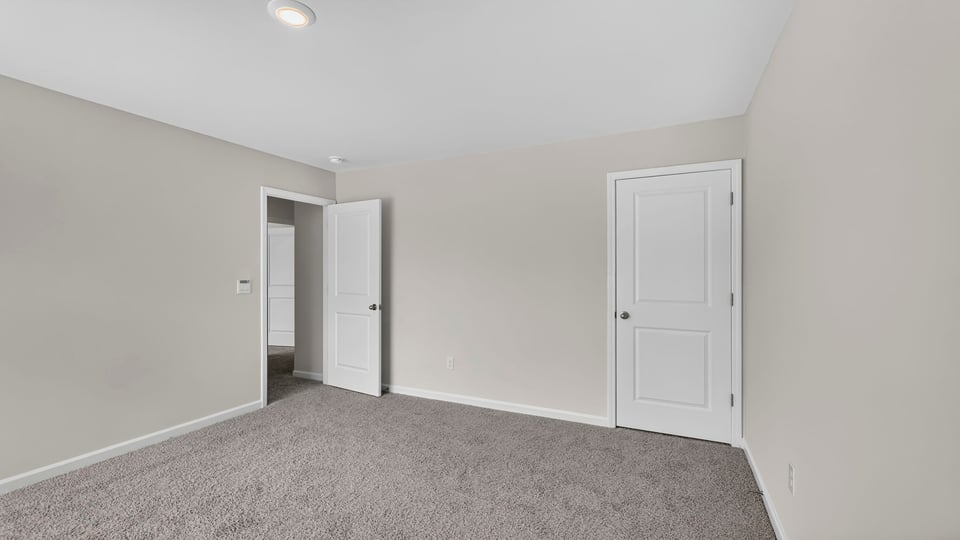 Bedroom with carpet and window.