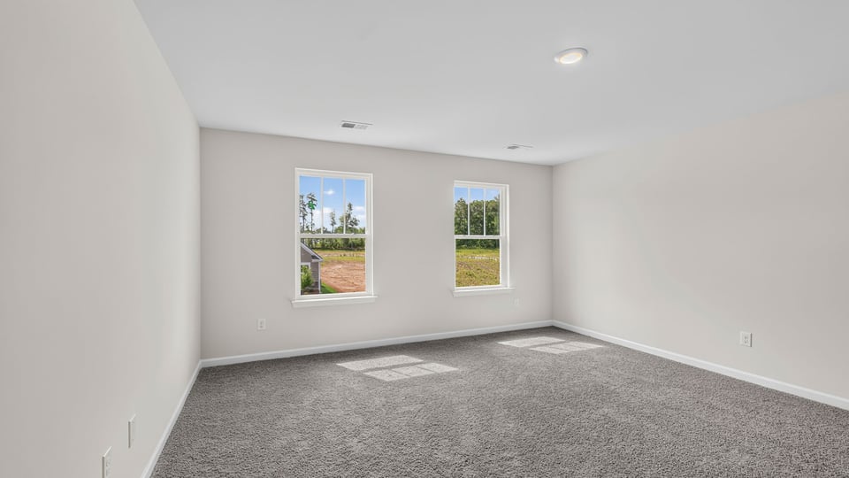 Bedroom with carpet and window.