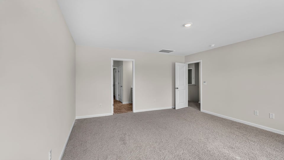 Bedroom with carpet and window.