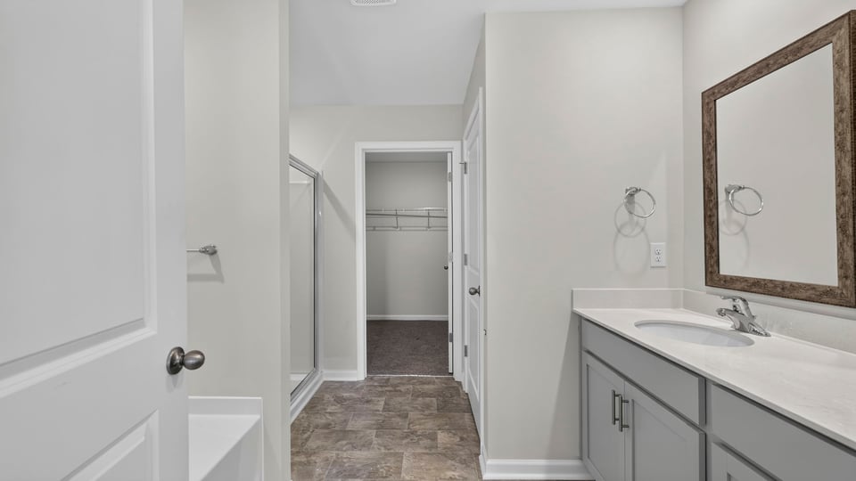 Bathroom with double vanity sink and closet.