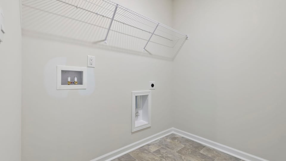 Laundry room with hanging storage racks.