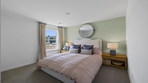 Bedroom with carpet and windows.