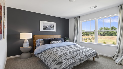 Bedroom with carpet and windows.