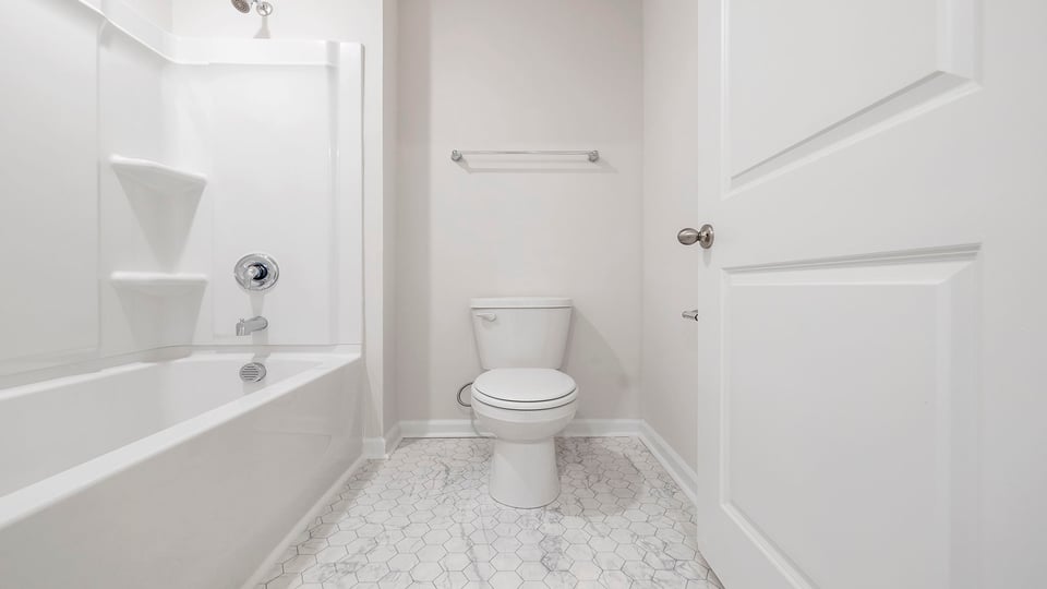 Separate shower area with combination shower / tub and toilet.