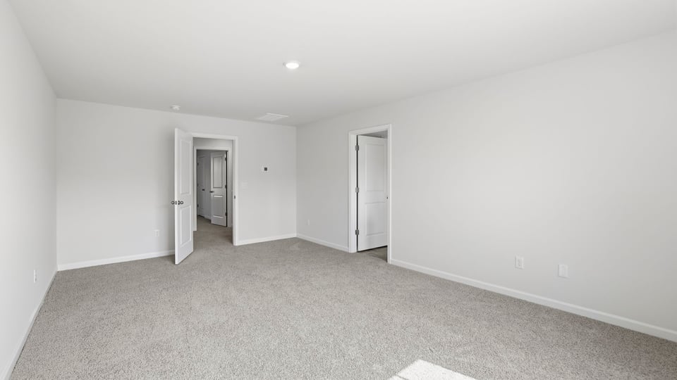 Bedroom with carpet and window.