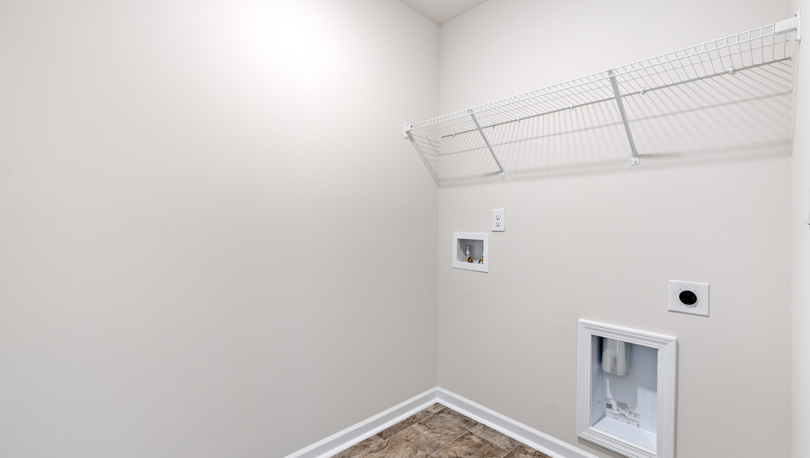 Laundry room with shelving.